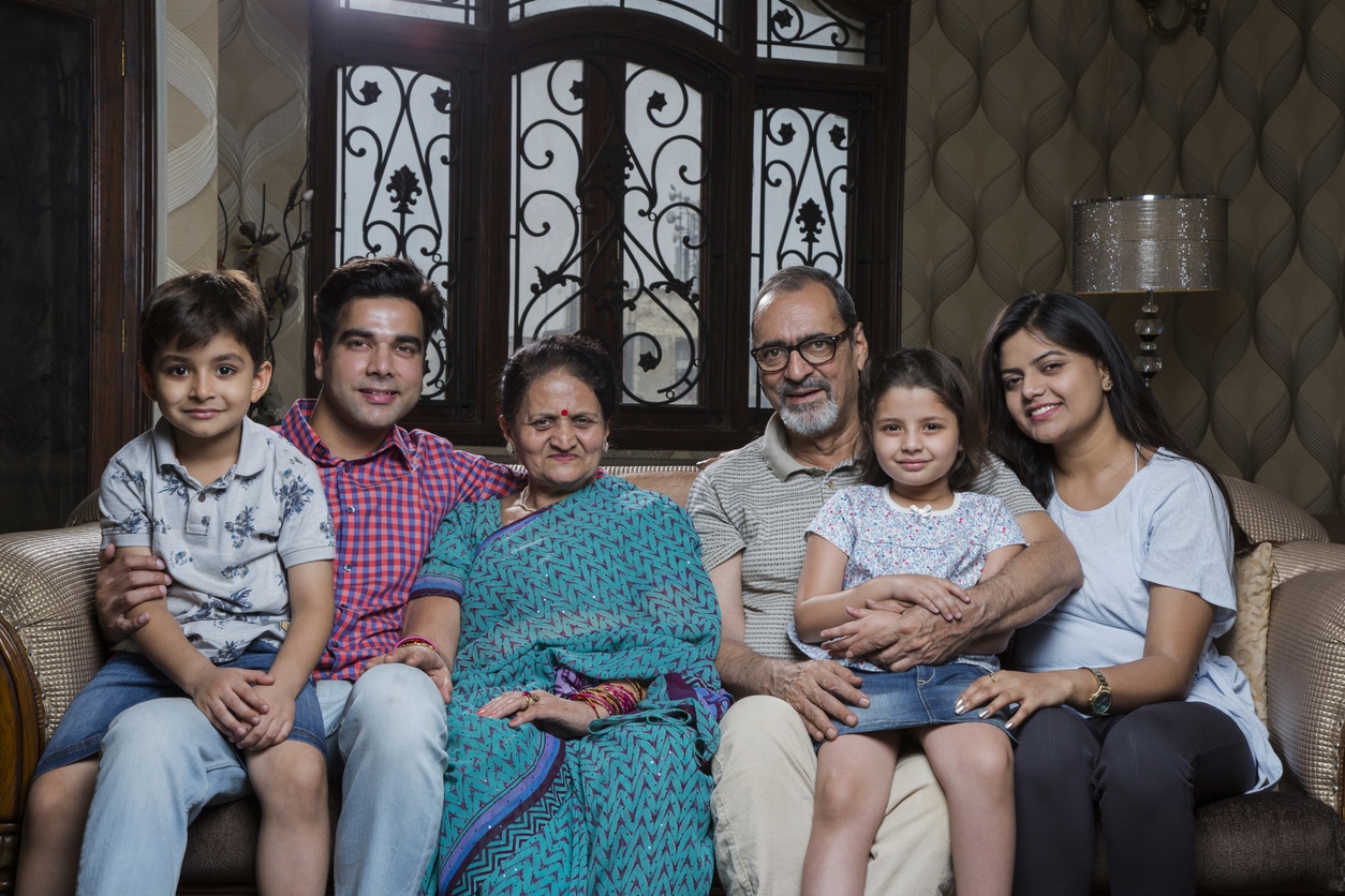 Multi generation family sitting on sofa in living room